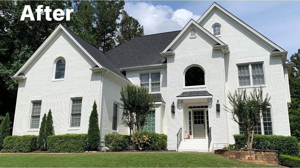 Brick home painted white, after