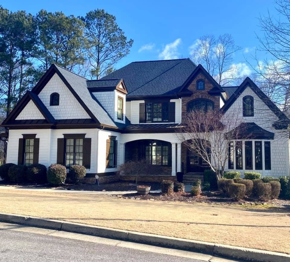 Canton, GA home with white siding, dark trim and stone accents