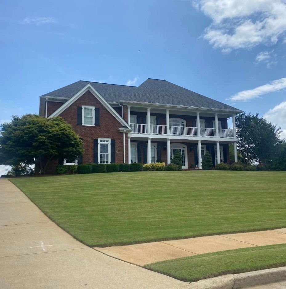 Red brick home with white columns and double front porches